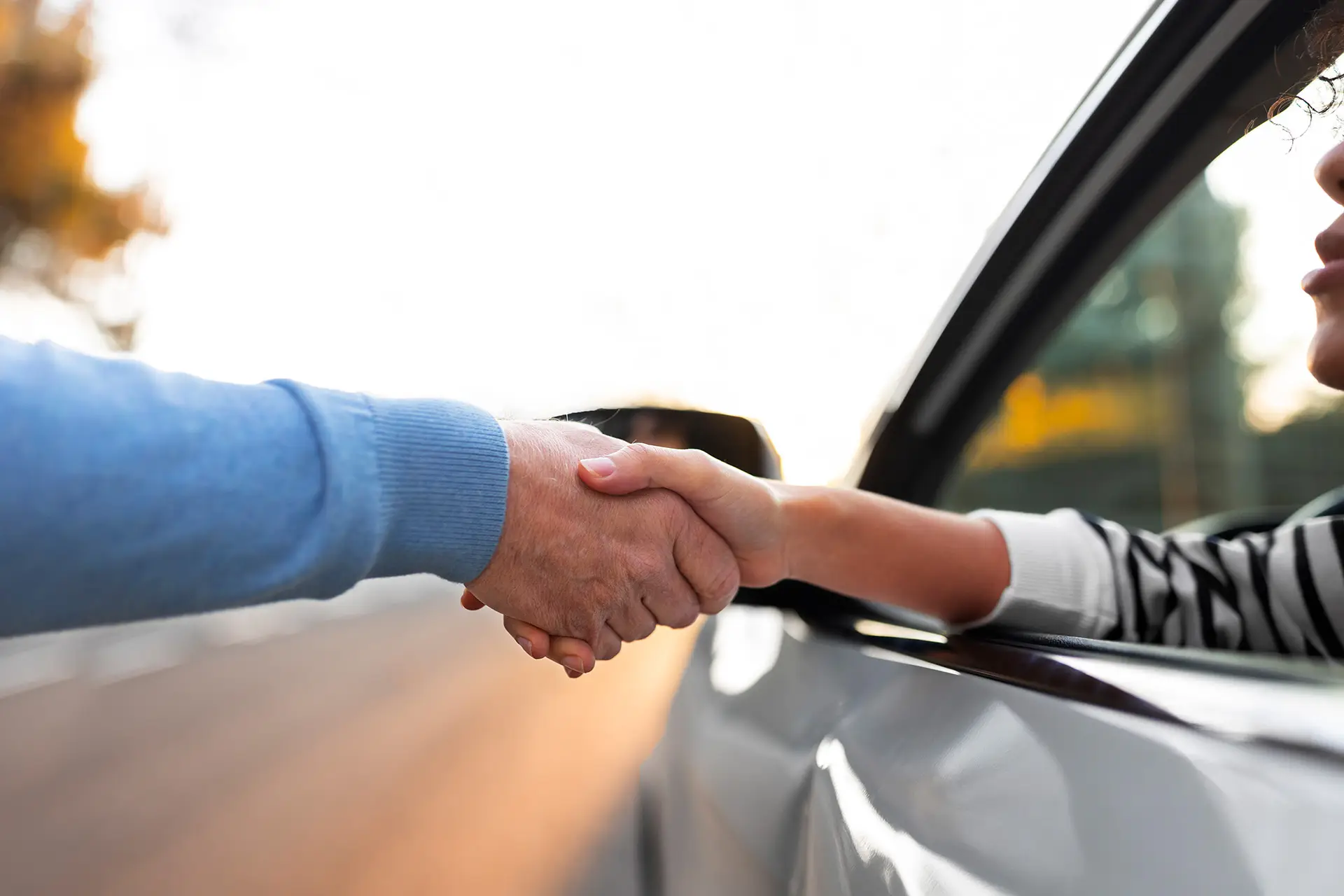 Two people shaking hands in a professional setting, symbolizing customer loyalty and strong business relationships.